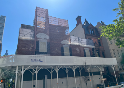 urban umbrella sidewalk shed below decoratively covered scaffolding