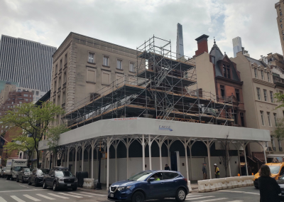 creative scaffolding engineering over slanted rootop, urban umbrella sidewalk shed
